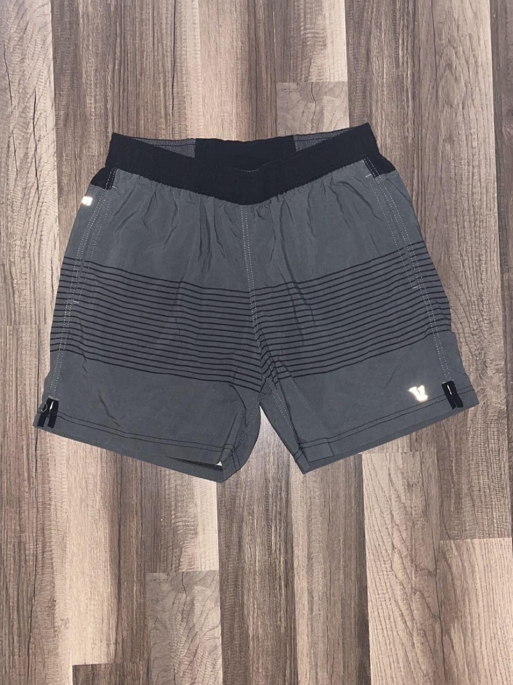 Vuori men’s medium grey and black shorts .